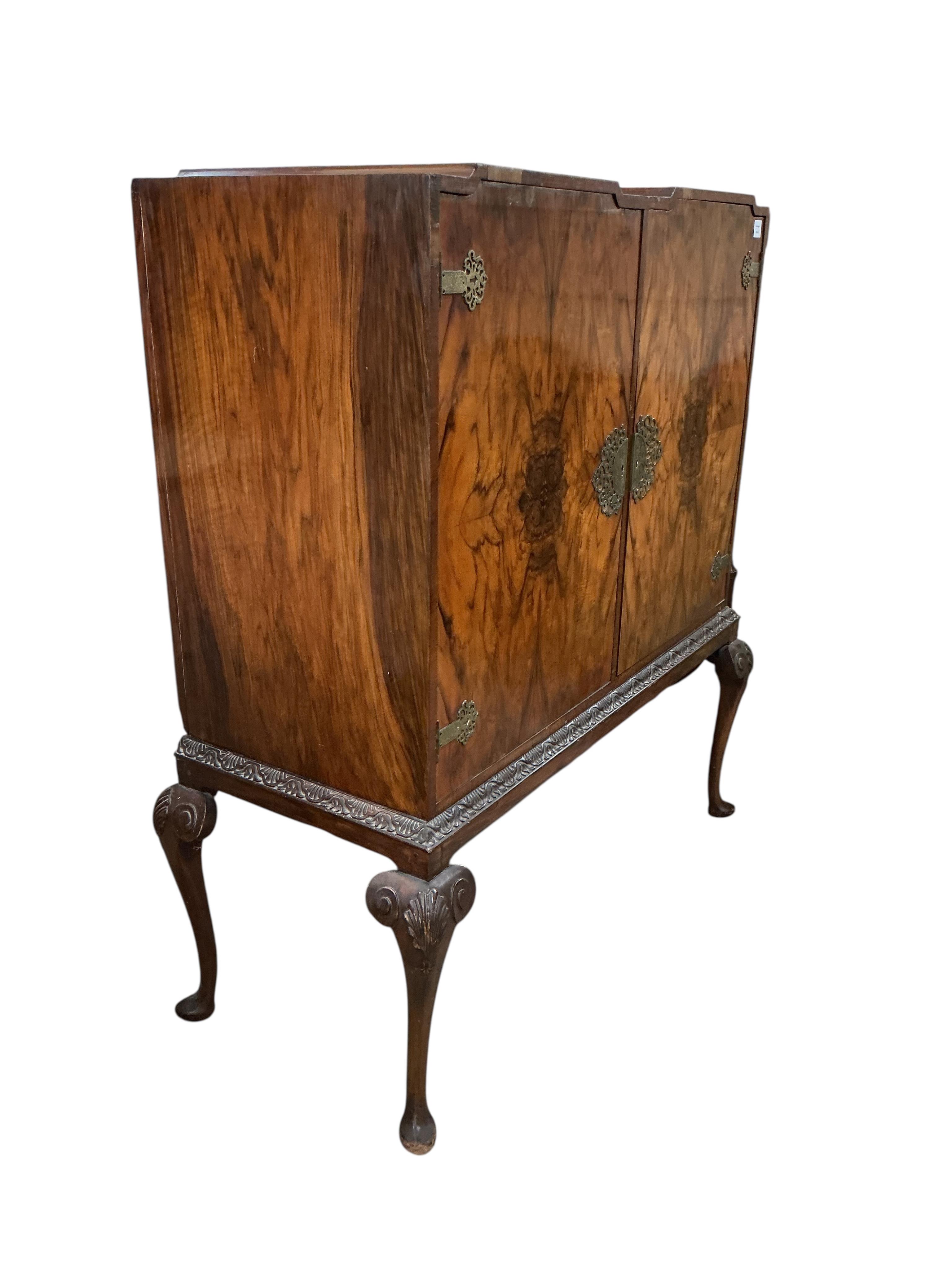A Queen Anne Revival walnut side cabinet, width 128cm, depth 56cm, height 140cm